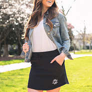 girl wearing monogrammed casual skirt in charcoal with white tank and denim jacket