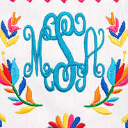 close up of monogram and embroidery pattern on white cabana clutch