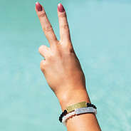 monogrammed beaded bracelets on hand making peace sign