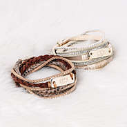 monogrammed wrap bracelet stacks on fur rug