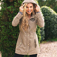 monogrammed khaki rain jacket and striped long sleeved t-shirt