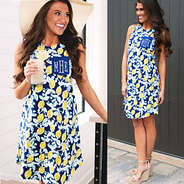 front and side views of monogrammed lemon swing dress with sun hat and lemonade