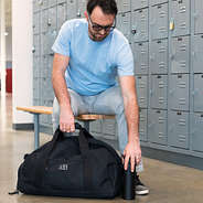 Male Model Holding Monogrammed Duffel Bag