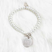monogrammed pearl bracelet on fur rug