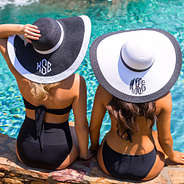 two girls wearing monogrammed beach hats
