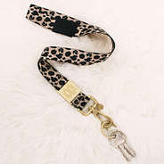 leopard breakaway lanyard on fuzzy rug