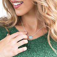 silver delicate disc necklace with green boyfriend sweater