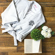gray monogrammed robe with book