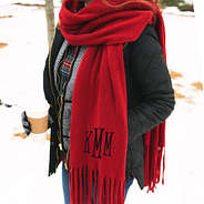 monogrammed red fringe scarf around neck in the snow