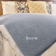 personalized with name woven  throw blanket on bed corner in slate blue