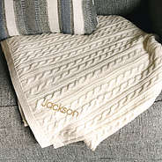 ivory throw blanket with name on couch with pillow