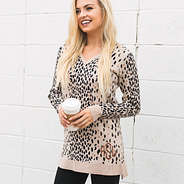 monogrammed leopard sweater tunic in front of white wall