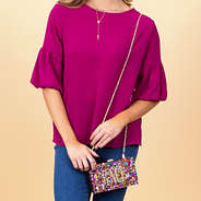 confetti box clutch on shoulder