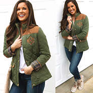 olive monogrammed quilted barn coat with white tee and monogrammed sneakers