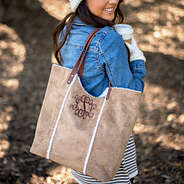 monogrammed faux shearling tote bag on girl wearing denim jacket