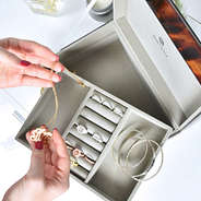 jewelry box with monogrammed necklaces and rings