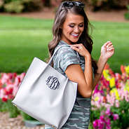 gray monogrammed tote bag with camo dress and flowers