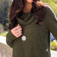 gold monogrammed pearl disc necklace and green sweater
