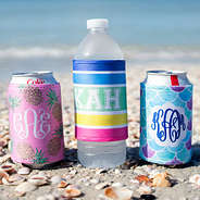 water bottle and coca cola with monogrammed drink insulators at the beach