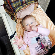 baby on changing pad with plaid diaper backpack