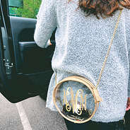 clear circle crossbody bag with boyfriend sweater on girl getting in car