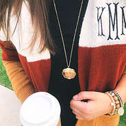 gold monogrammed scallop necklace with colorblock cardigan