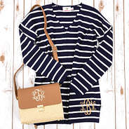 navy v-neck sweater with monogrammed straw crossbody