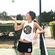 girl at tennis courts wearing monogrammed shorts and tank