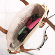 inside of round straw purse with crossbody strap