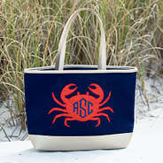 monogrammed crab beach tote sitting in the sand at the beach