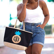 girl with monogrammed pineapple tote on arm