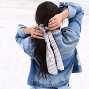 tying seersucker scrunchie with jean jacket