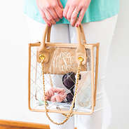 girl holding monogrammed clear handbag with zipper pouch inside