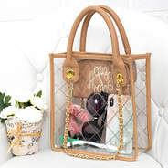 monogrammed clear handbag sitting on white chair with flowers