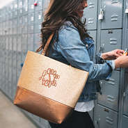 monogrammed gold glitter tote on girl's shoulder beside lockers