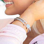 silver monogrammed bangles on arm