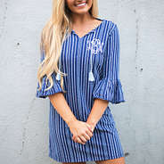 bell sleeve dress in front of white wall