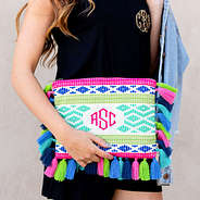 monogrammed tropical clutch with black romper and jean jacket