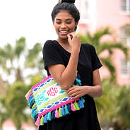 girl holding brightly colored monogrammed geo clutch