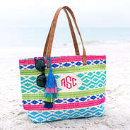 colorful geometric print monogrammed tote sitting on the beach