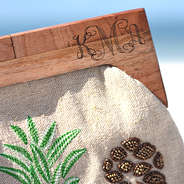 detail shot of monogrammed pineapple wooden handle clutch