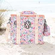 monogrammed coral floral cooler on beach shore