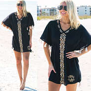 blonde in monogrammed black tassel coverup at the beach