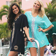 girls wearing monogrammed butterfly tassel kimonos at the pool