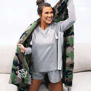 girl wrapped in soft camo blanket on the couch