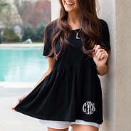 black monogrammed peplum tee near pool with gold necklace