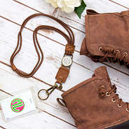 flat lay of duck boot lanyard with duck boots on white wood