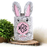 monogrammed bunny koolie next to plant