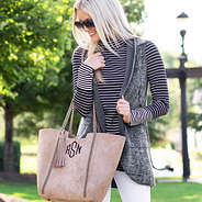 reversible gray fur vest with purse and white jeans