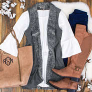 gray reversible vest flat lay with boots and suede purse